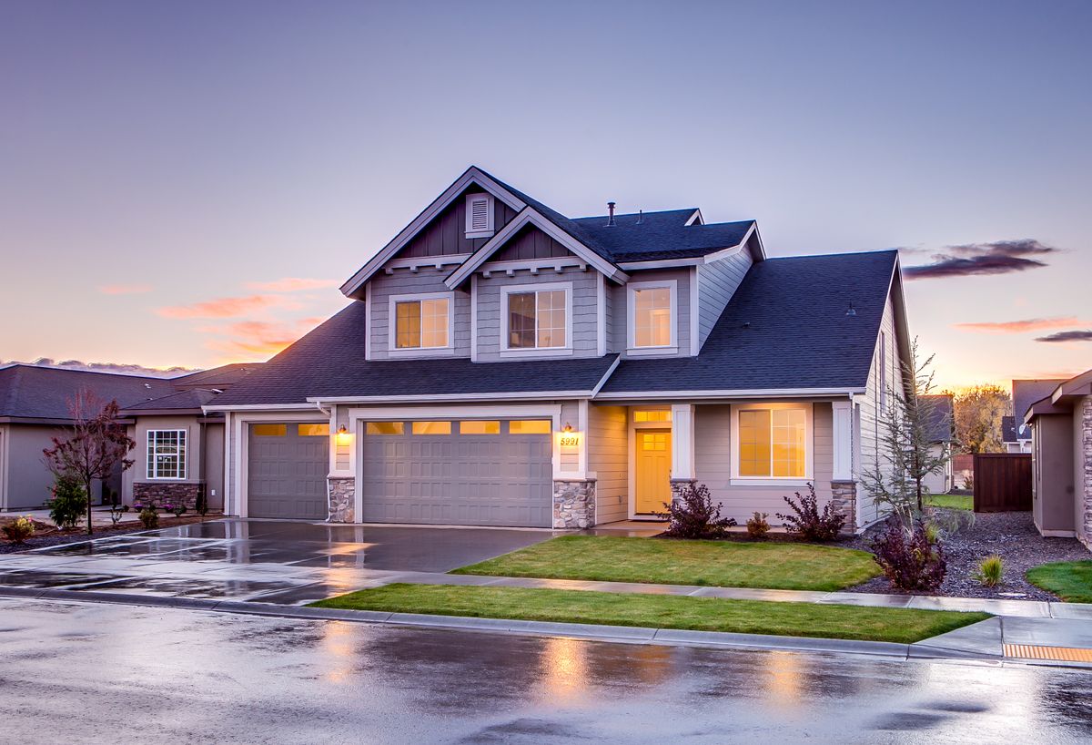 Suburban home glowing at sunset (stock image — to be replaced with a real project photo)