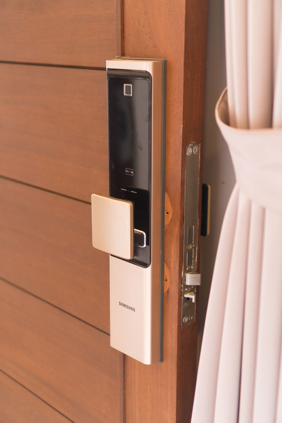 Smart door lock on a wood front door (stock image — to be replaced with a real project photo)